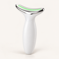 Appareil de massage visage et cou blanc avec tête chromée et lumière verte